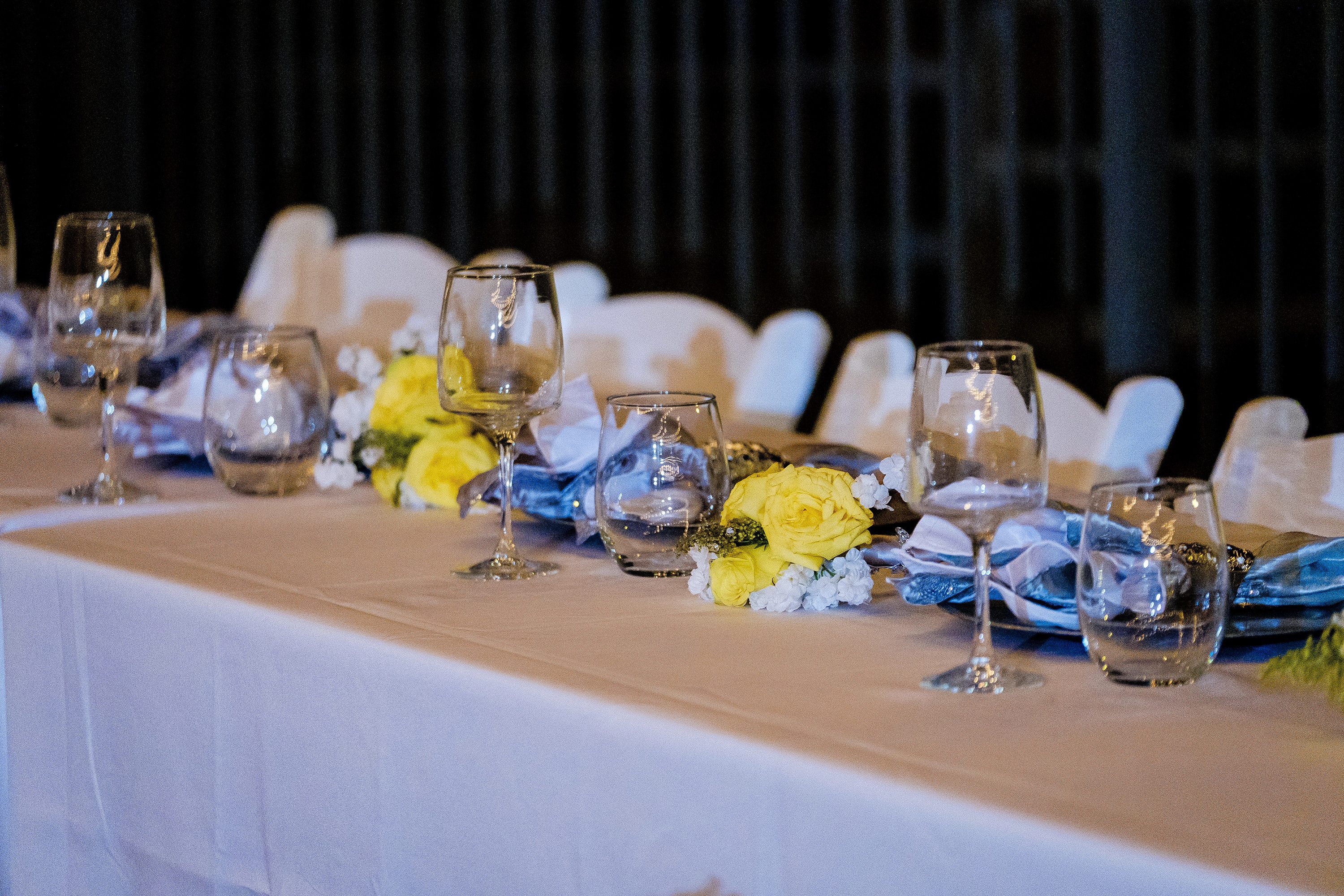 details of the head table at a backyard wedding reception
