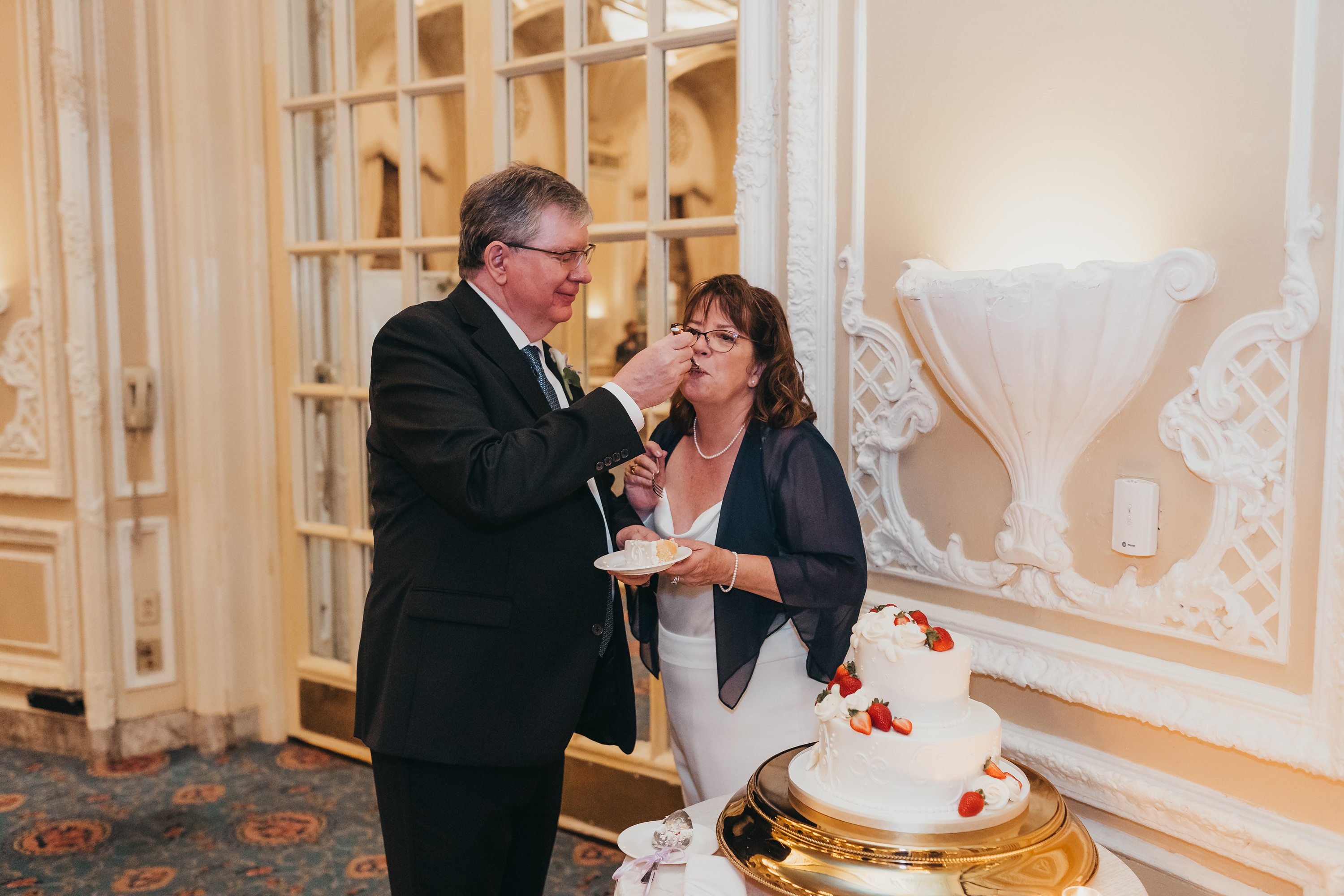 2020 covid wedding,fairmont hotel copley,dessert works bakery boston,couple feeding each other wedding cake