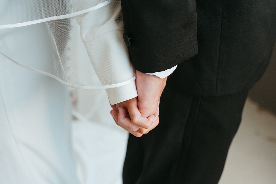 Bride and groom exchanging vows in the courtyard of the Four Seasons New Orleans.,Bride Alexandra in her Vagabond Bridal gown holding a romantic bouquet by Leaf and Petal