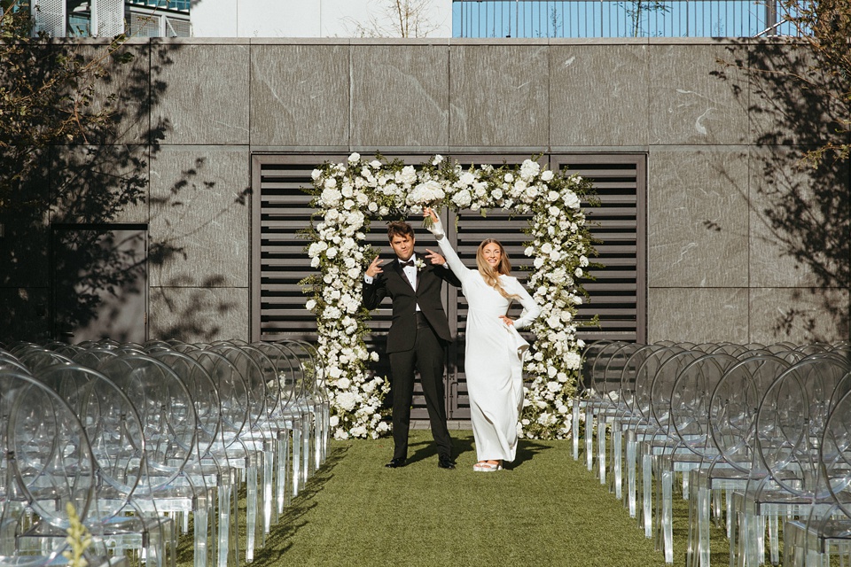 Bride Alexandra in her Vagabond Bridal gown holding a romantic bouquet by Leaf and Petal