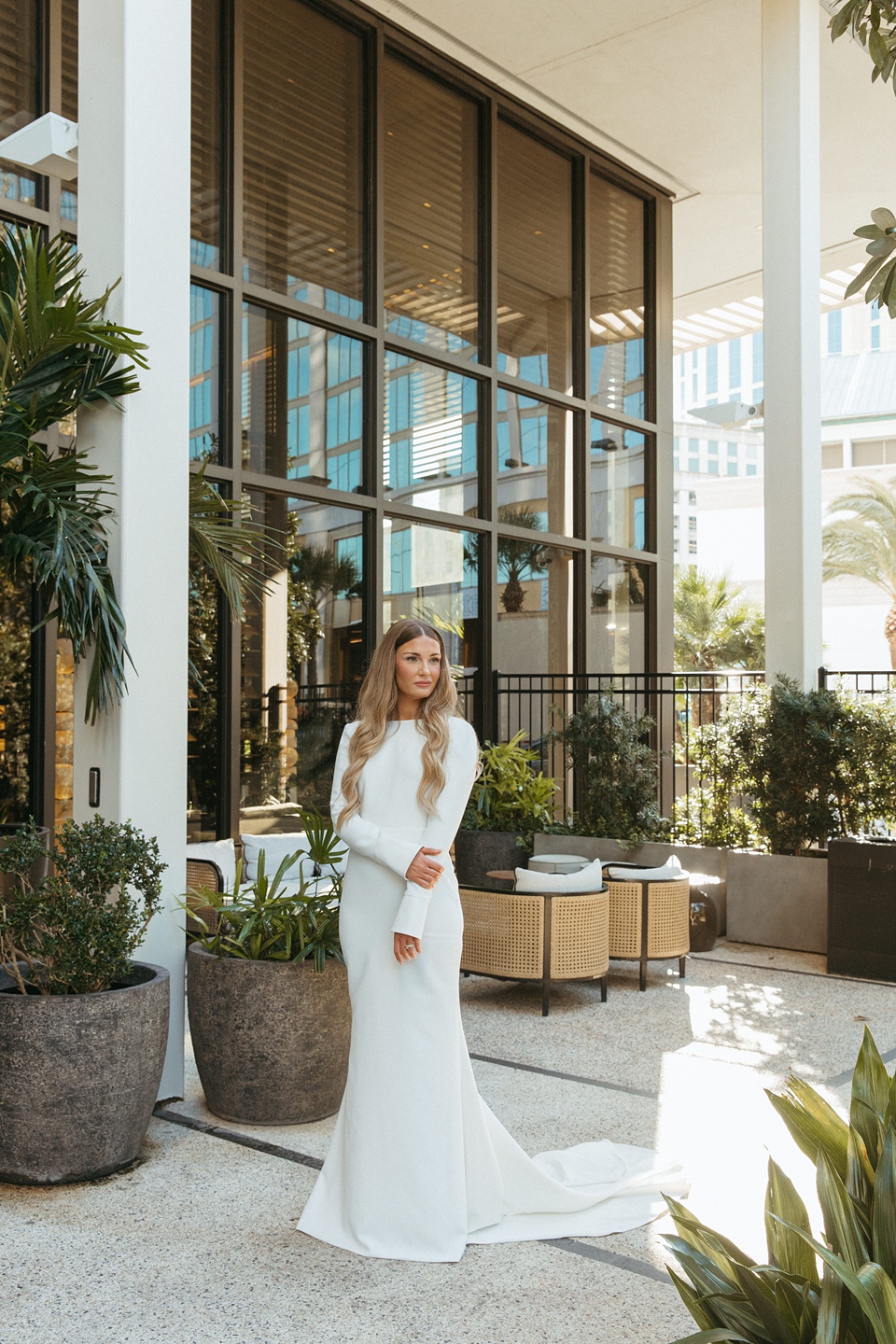 Bride and groom exchanging vows in the courtyard of the Four Seasons New Orleans.,Romantic floral arrangements by Leaf and Petal
