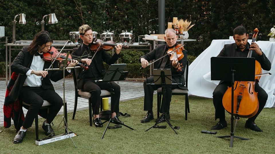 Bride and groom exchanging vows in the courtyard of the Four Seasons New Orleans.,Romantic floral arrangements by Leaf and Petal