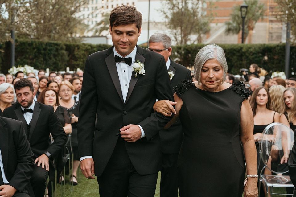 Bride and groom exchanging vows in the courtyard of the Four Seasons New Orleans.,Romantic floral arrangements by Leaf and Petal