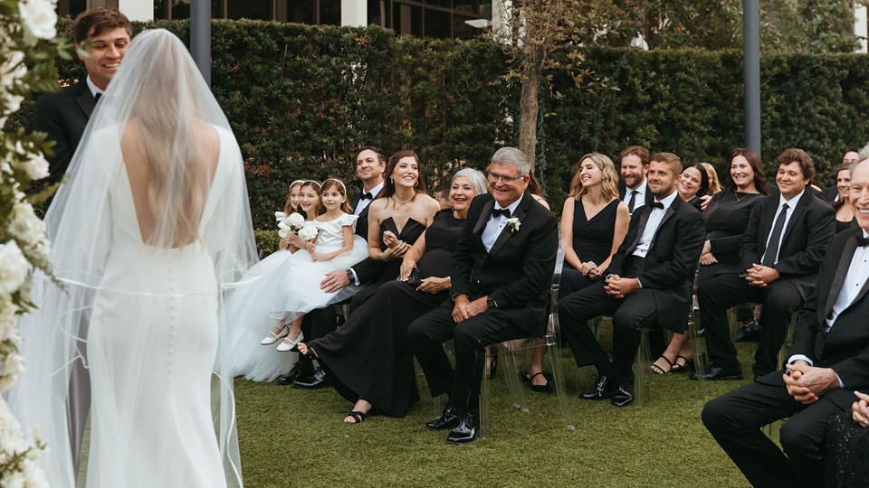 The Four Seasons courtyard set up for an intimate outdoor wedding ceremony.,Bride and groom exchanging vows in the courtyard of the Four Seasons New Orleans.