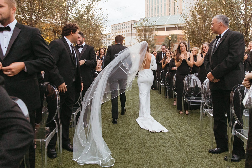 The Four Seasons courtyard set up for an intimate outdoor wedding ceremony.,Bride and groom exchanging vows in the courtyard of the Four Seasons New Orleans.