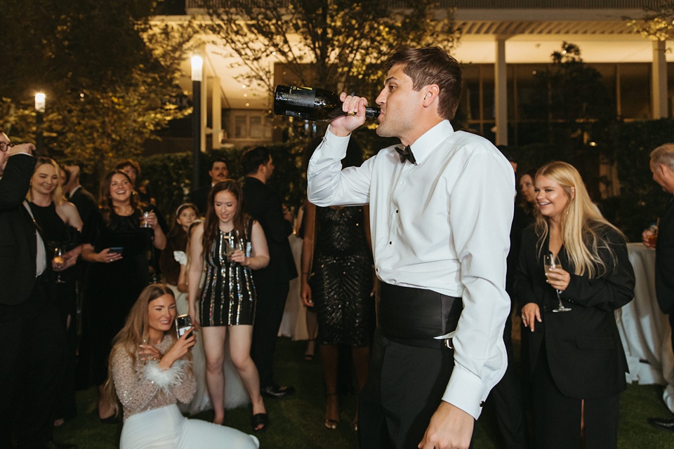 Bride and groom exchanging vows in the courtyard of the Four Seasons New Orleans.,Romantic floral arrangements by Leaf and Petal