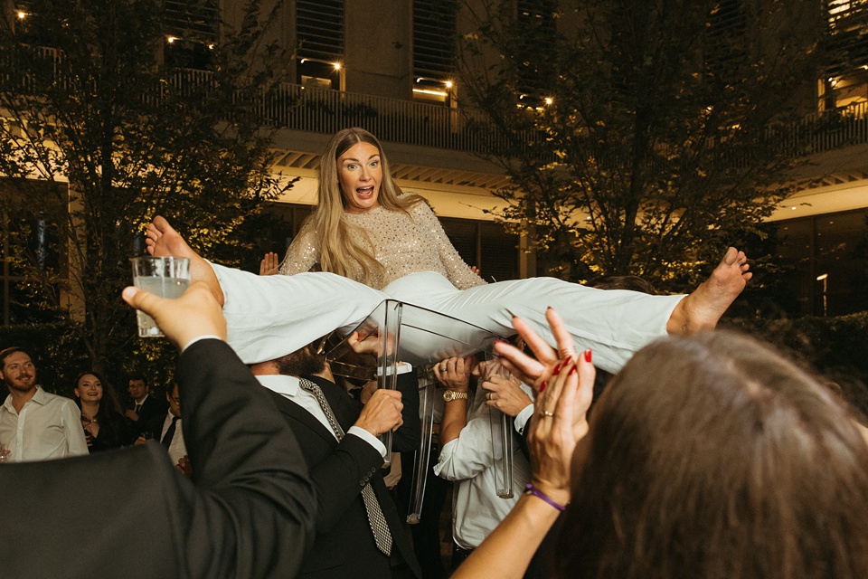 The Four Seasons courtyard set up for an intimate outdoor wedding ceremony.,Bride and groom exchanging vows in the courtyard of the Four Seasons New Orleans.