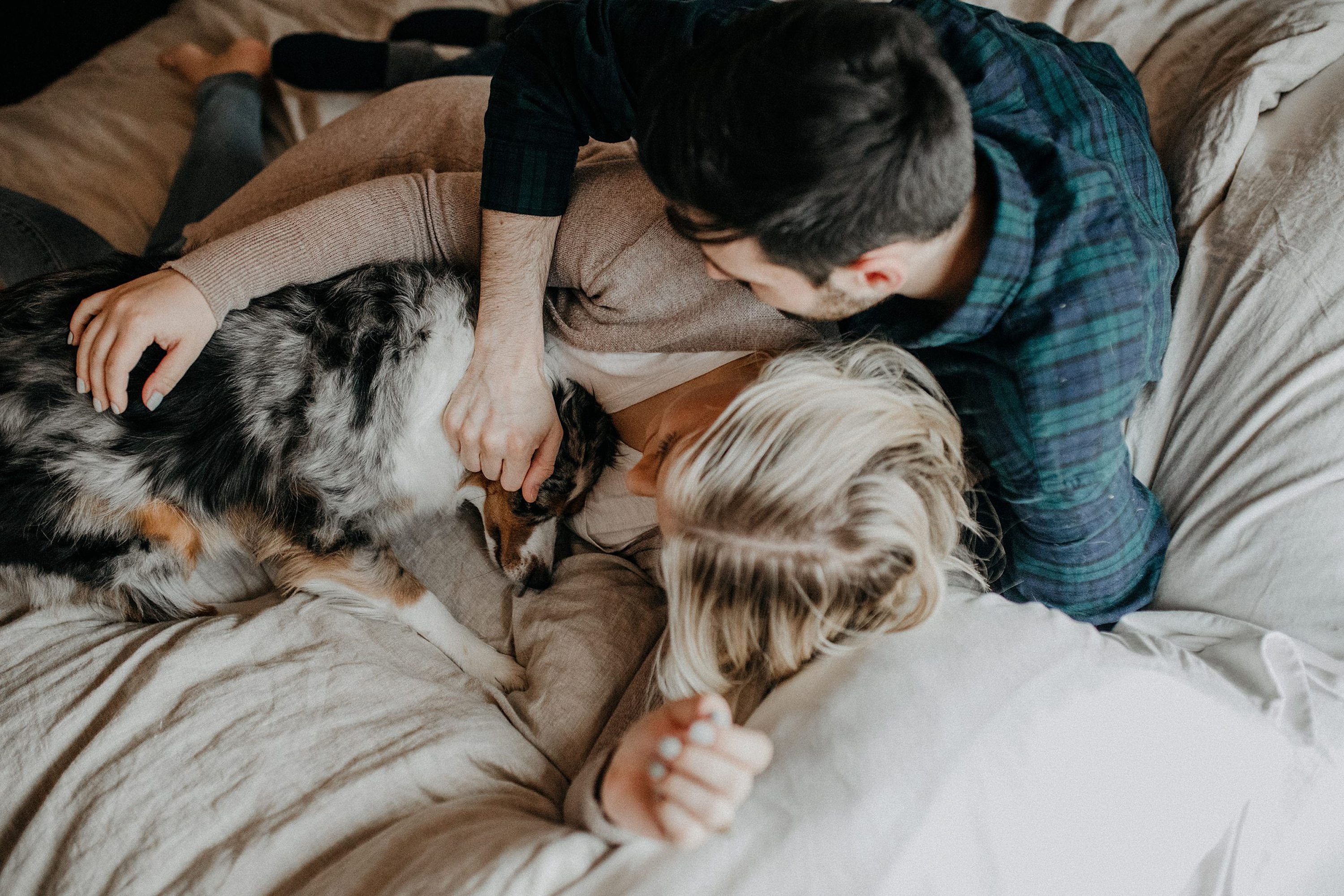cute couples photos,in home engagement session,candid engagement session,winter engagement session,living room engagement session,engagement photos with dog,couples photos with dog