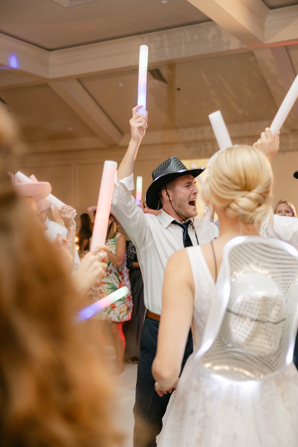  the couple bid farewell to their guests with a grand gesture. Silver streamers filled the air as the bride and groom made their way to a vintage luxury car,Texas Wedding Photographer