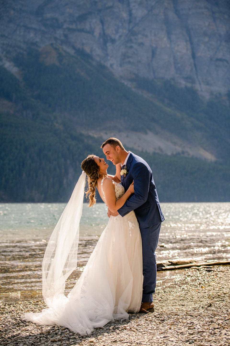 Perfect Lakeside elopement at Rising Sun along St. Mary Lakeshore in Glacier National Park surrounded by friends and family.,Mountain Wedding,Adventure Elopement