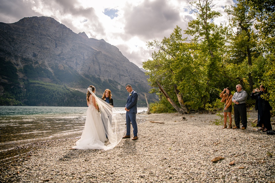 Perfect Lakeside elopement at Rising Sun along St. Mary Lakeshore in Glacier National Park surrounded by friends and family.,Mountain Wedding,Adventure Elopement