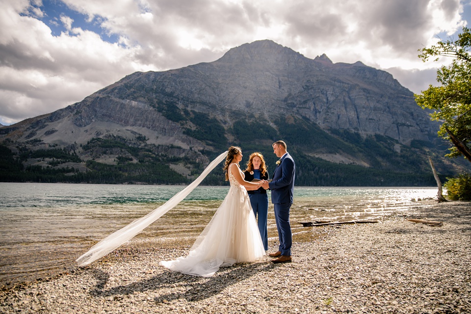 Perfect Lakeside elopement at Rising Sun along St. Mary Lakeshore in Glacier National Park surrounded by friends and family.,Mountain Wedding,Adventure Elopement