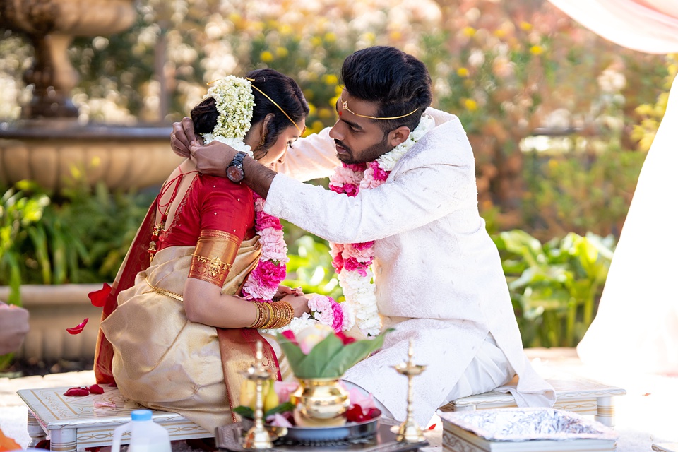 Photo of South Indian couple in colour-coordinated outfits on their wedding  day